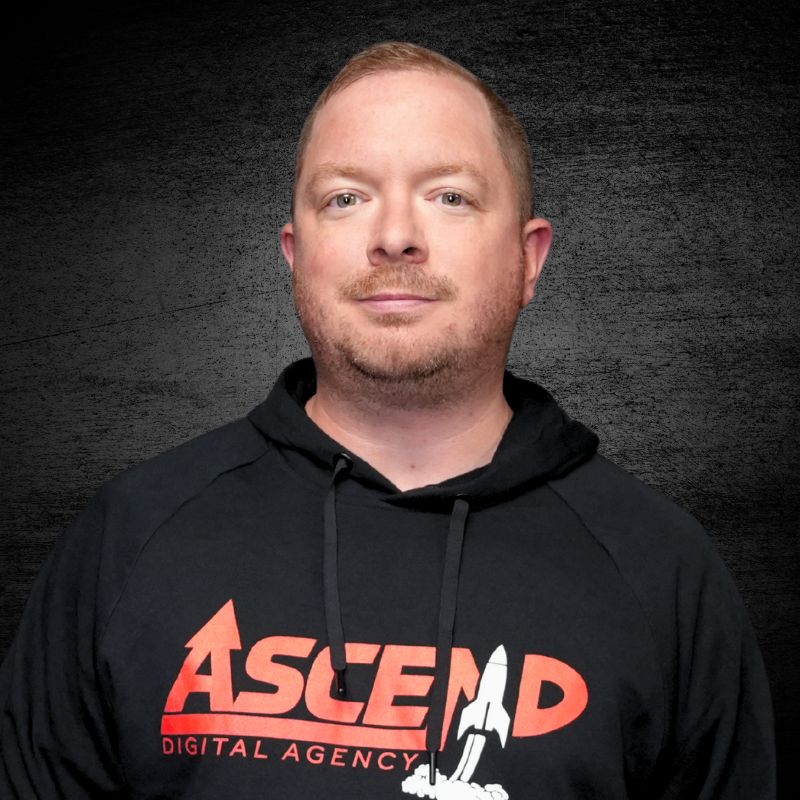 Man wearing black 'Ascend Digital Agency' hoodie on dark background.