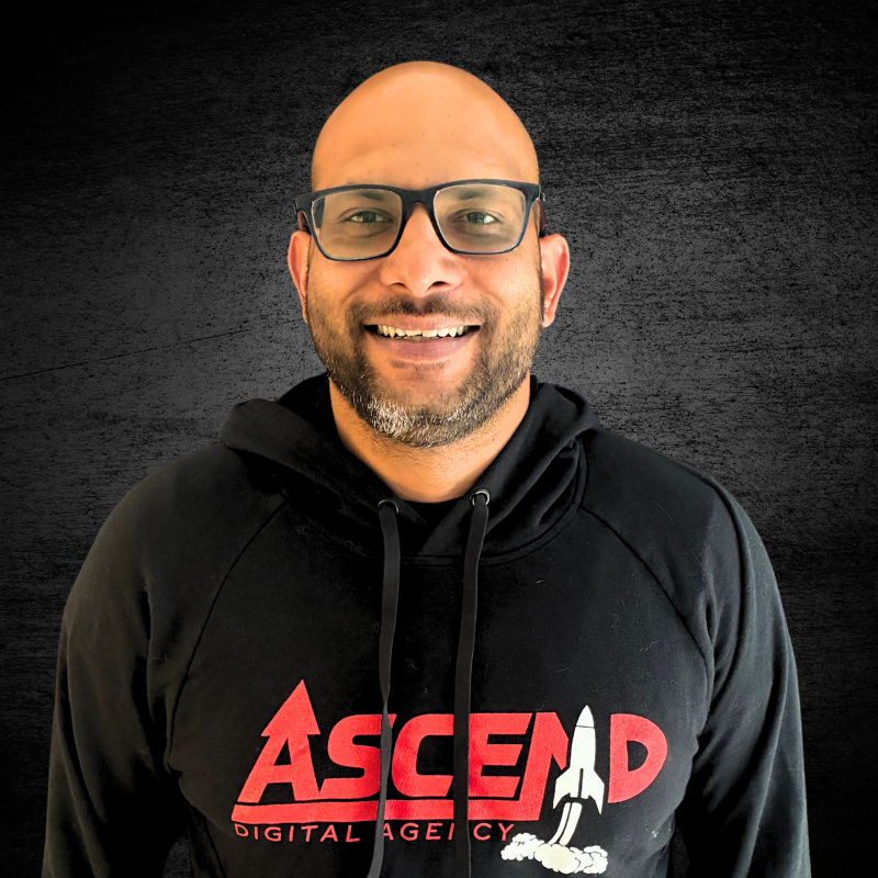 Smiling person wearing an Ascend Digital Agency hoodie